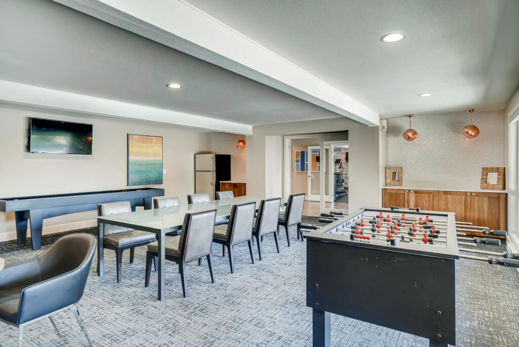 Clubhouse lounge with tables and games