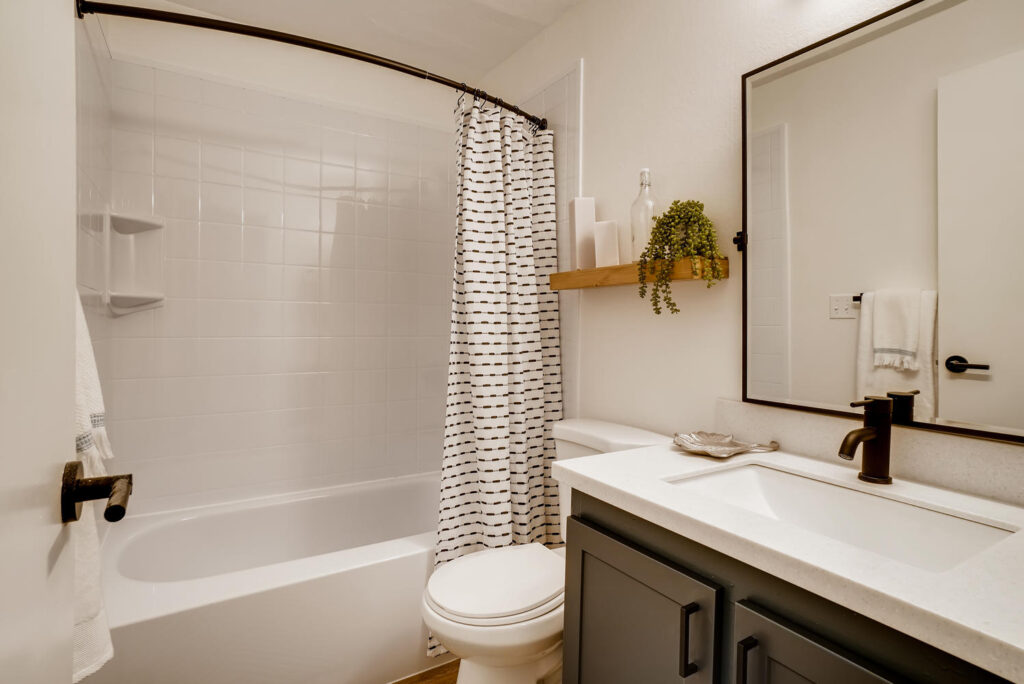 Bathroom with tub shower at Park 120 apartment rentals in Everett