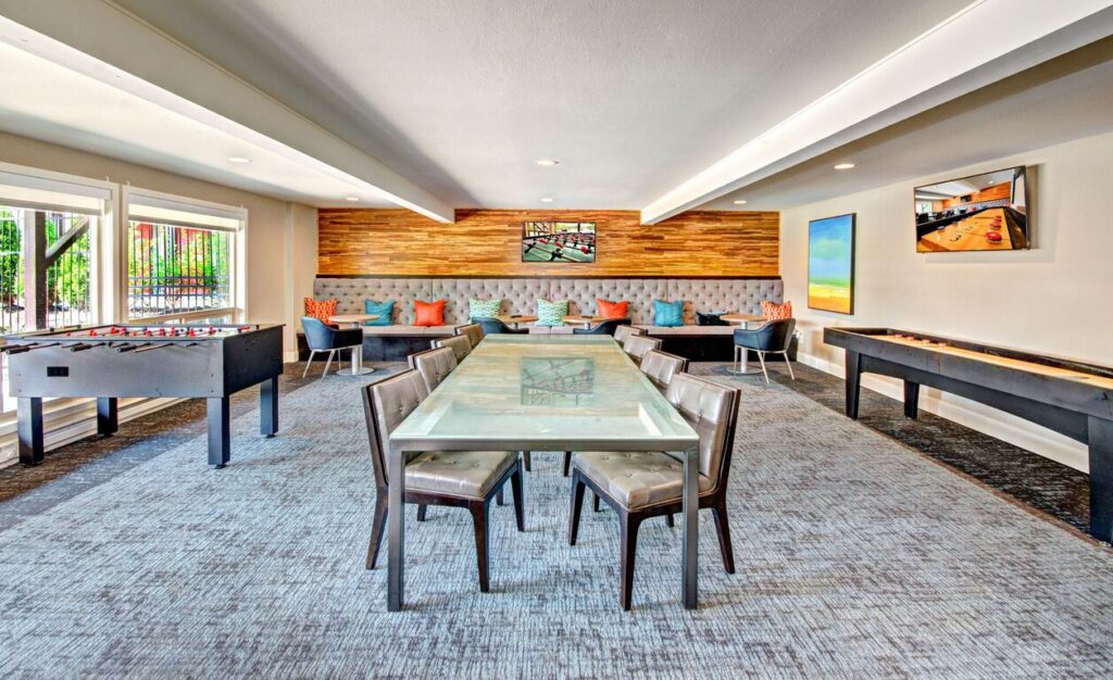 Clubhouse lounge with tables, chairs, and games in our Snohomish, WA apartments