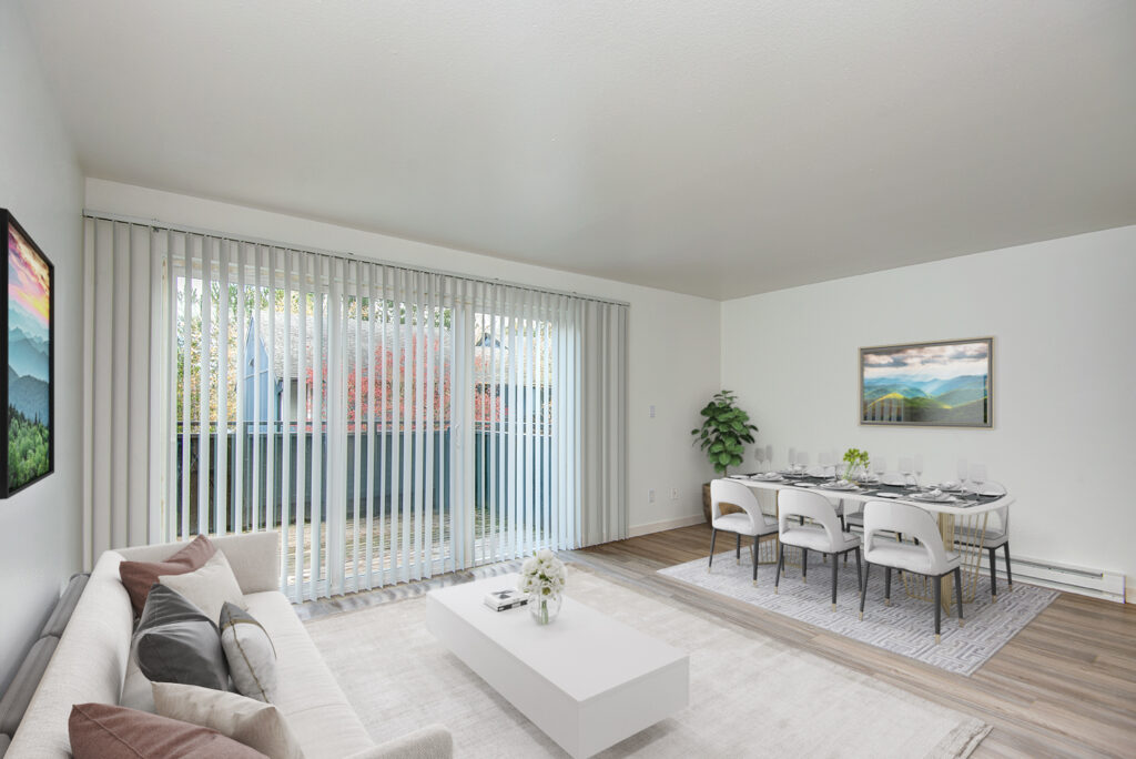 Living Room with sliding glass door leading to outside and dining room in our apartments in Everett, WA.